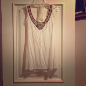 White sleeveless shirt, beaded necklace attached