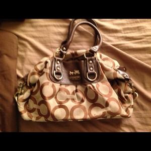 Brown coach bag with rip on zipper
