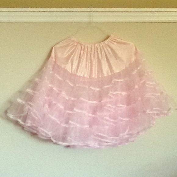 Knee length light pink tulle petticoat.