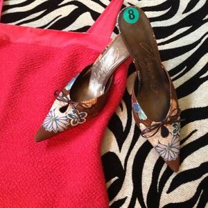 Small brown heel with flower detail.