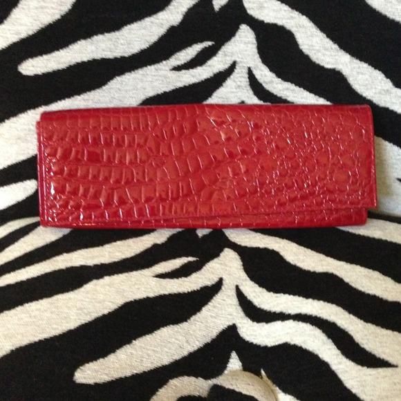 Red clutch with alligator detail.