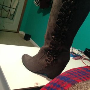 Gray ruffled wedge boots.