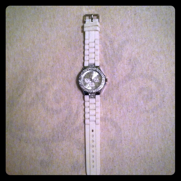 White rubber watch with diamonds around center.