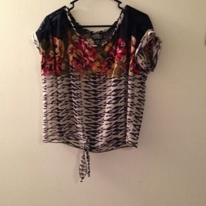 Short sleeve sheer floral shirt.Hits at the waist.