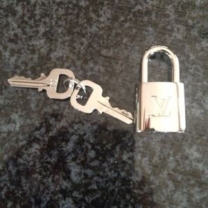 Sold Authentic LV lock and keys silver color
