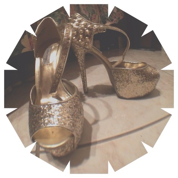 Gold high heels with spikes in the back.