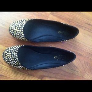 Gold color studded black flats.