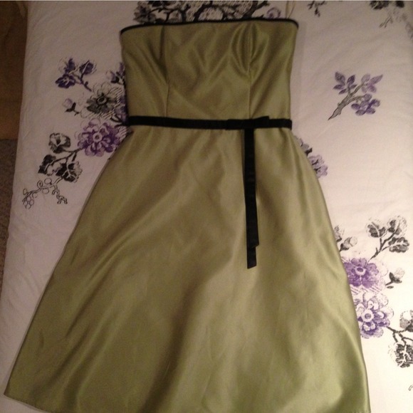 Light green dress with black bow and black trim.