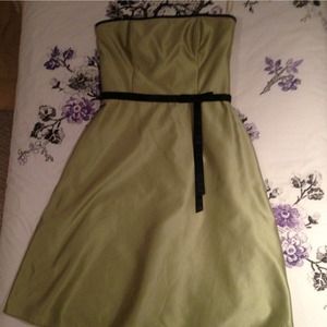 Light green dress with black bow and black trim.