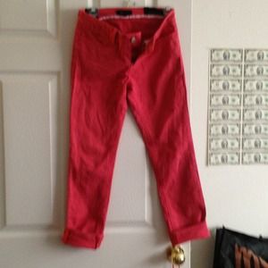 Coral colored jeans.