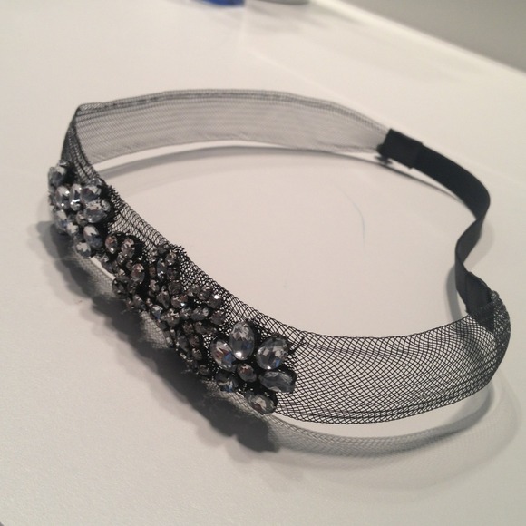 Black mesh headband with rhinestone flower design
