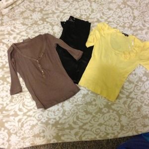 Set of black skinny pants, yellow top, brown top.