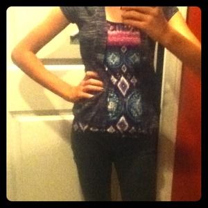 A Aztec patterned shirt, a striped vest,+ necklace