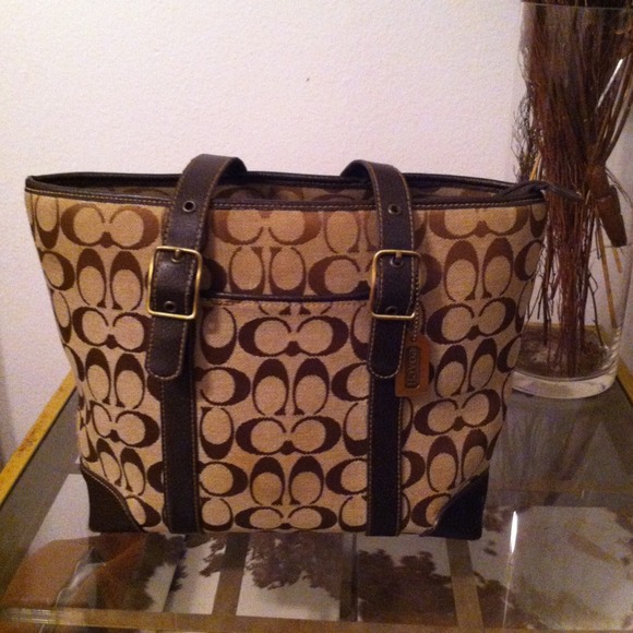 Gentle worn brown Coach signature bag.