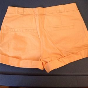 Peach colored shorts.