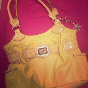 A sienna Ricchi purse in yellow.