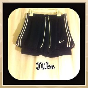 Nike black shorts with white stripes down sides.
