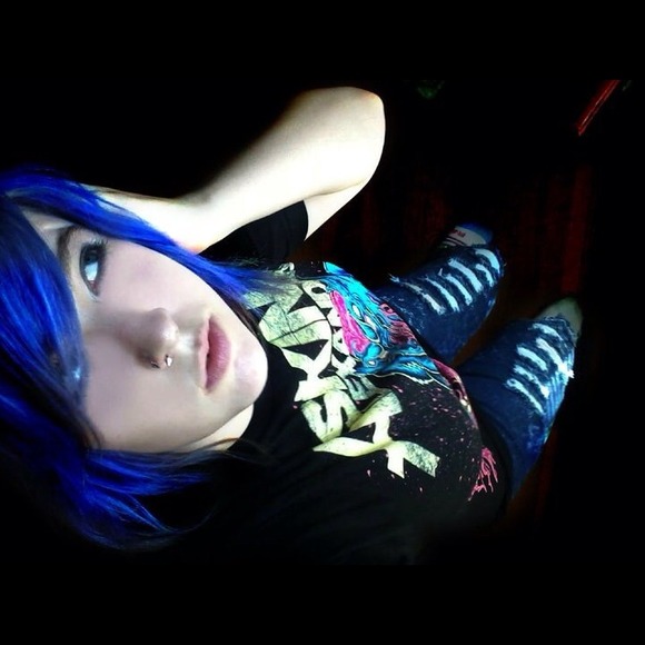 Blue, paint spattered, ripped, skinny jeans.