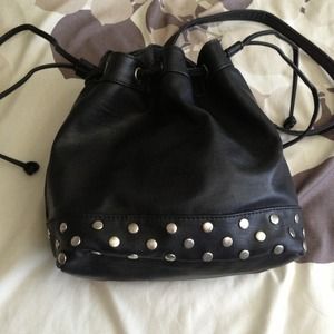 Studded bottom bucket cross body bag.