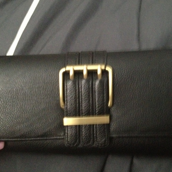 Black wallet with gold tone hardware.