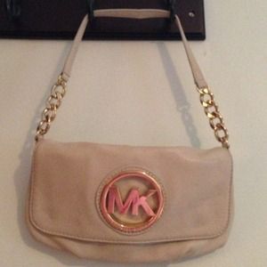 Michael Kors bag with gold metal detailing.