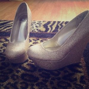 Platform gold wedged heels.