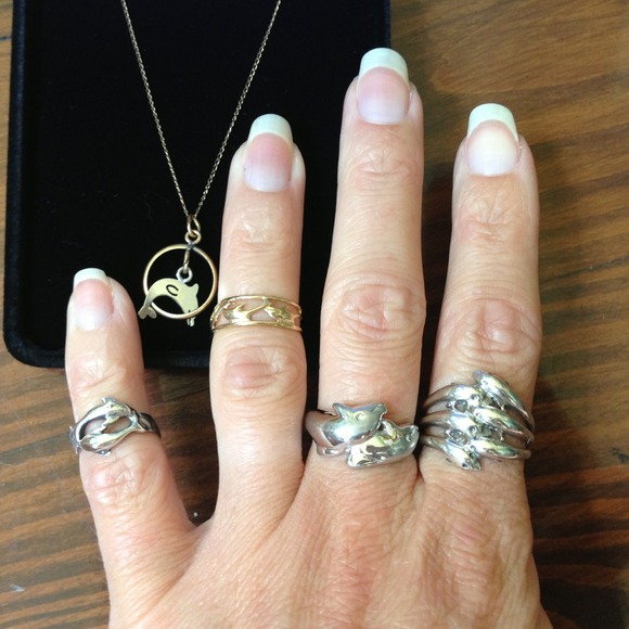 Lot of dolphin jewelry.