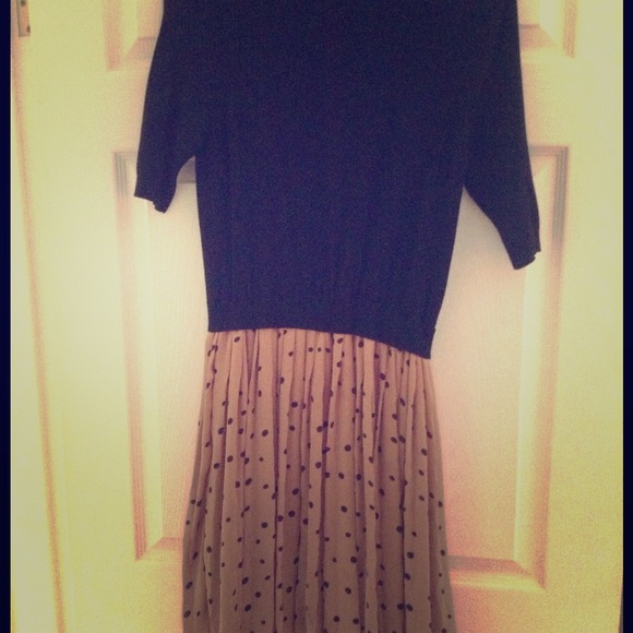 Taylor dress. Black sweater top, pleated skirt.