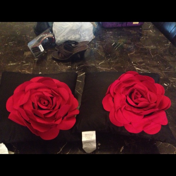 2 black throw pillows, with red colored flowers