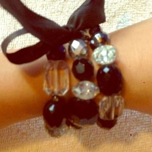 A bundle of bracelets with a bow