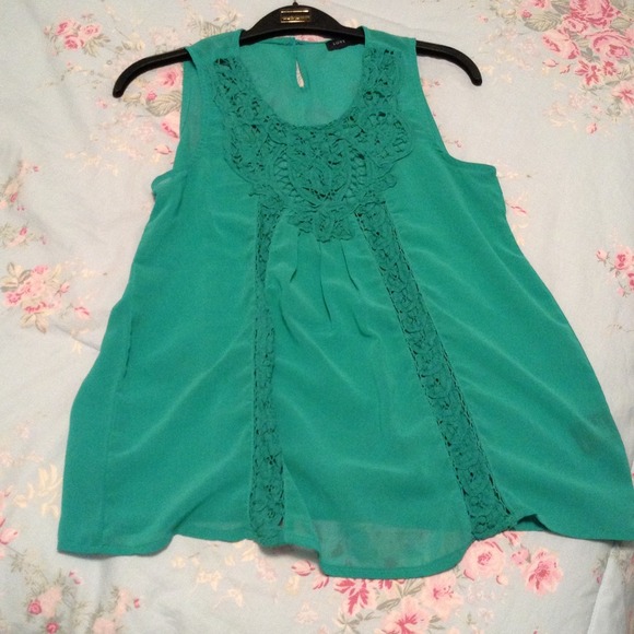 A green tank top with a lace pattern.