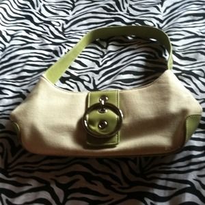 Green and beige handbag with buckle decal.