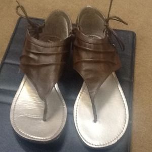Brown leather thong sandals.