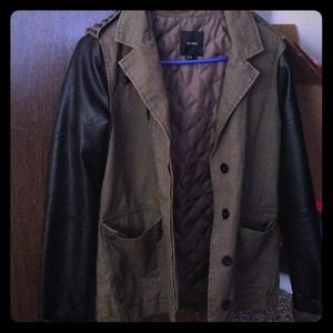 Green jacket with leather sleeves and necklace