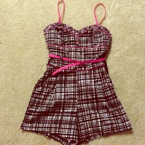Black and white striped romper with pink trim