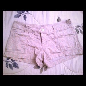 Beige shorts with faint floral print