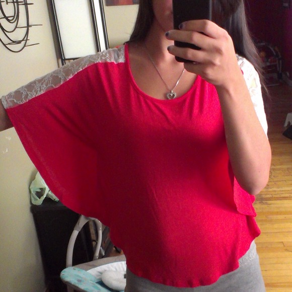 Flowy red dolam top with white lace on shoulders