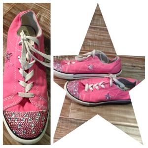 Pink bedazzled converse shoes.