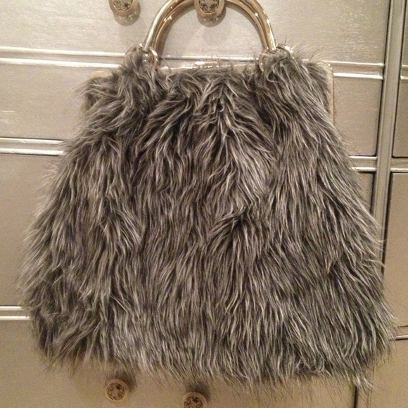 Asymmetrical faux fur handbag.