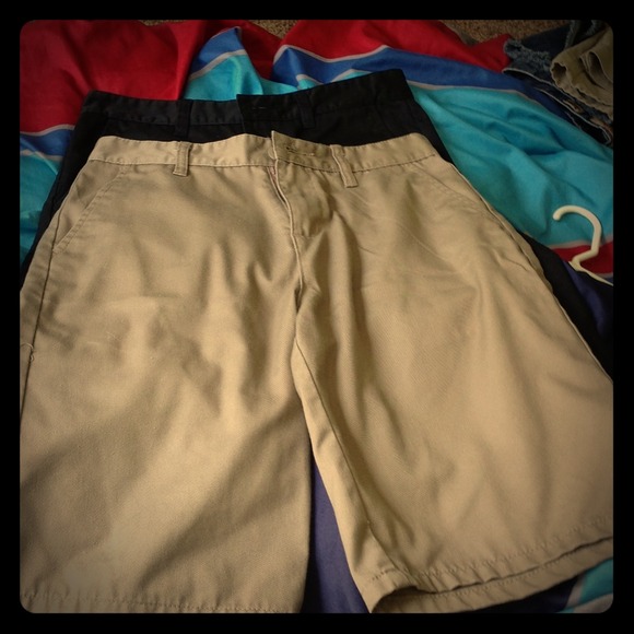 khaki and black pair of blue crown men's shorts,