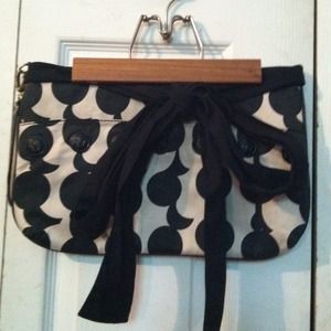 Under the arm black and white bag