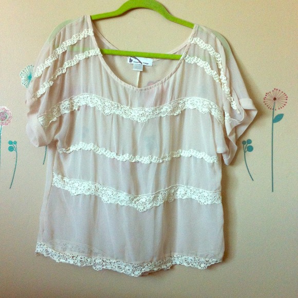 Sheer cream top with lace trims. Size L.