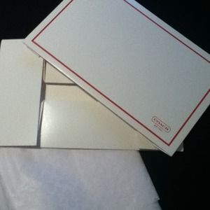 New unfolded coach box with tissue paper.