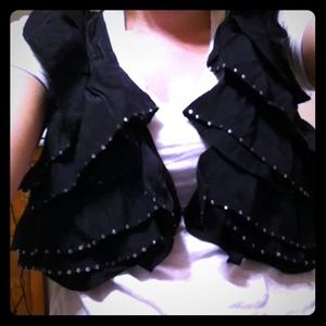A little black vest with gold flims on the edges