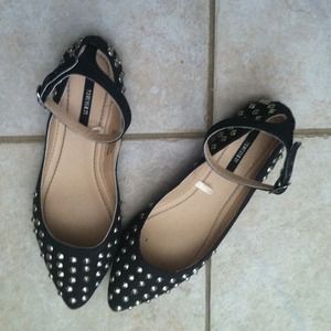 Black denim spiked flats.