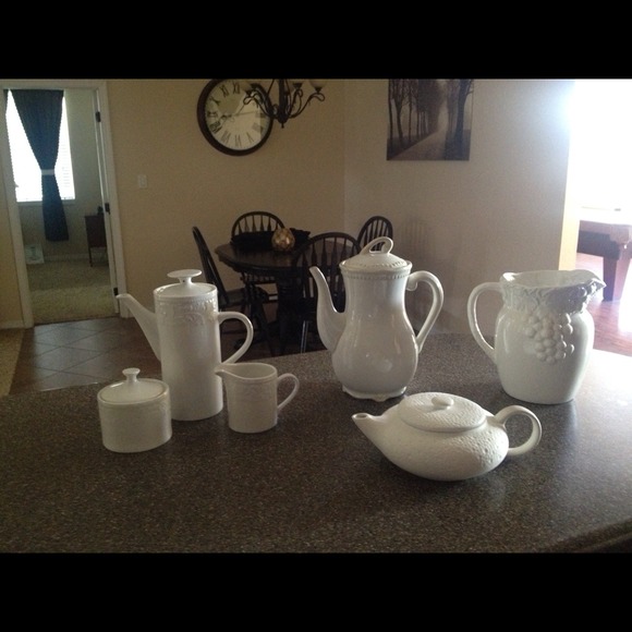 Assortment of white ceramic tea pots.