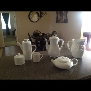 Assortment of white ceramic tea pots.