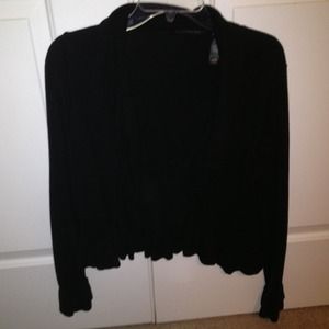 Black short/ shrug style sweater with ruffles.