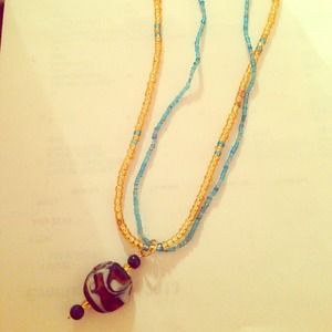 Blue and gold beaded necklace with pendant.