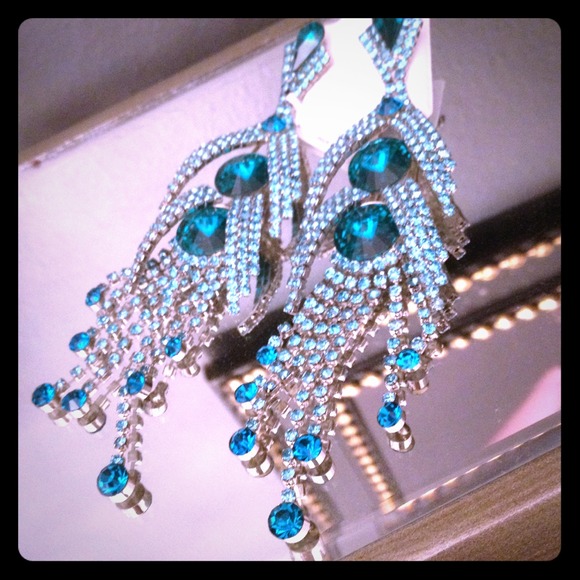 Chandelier crystal earrings on surgical post.